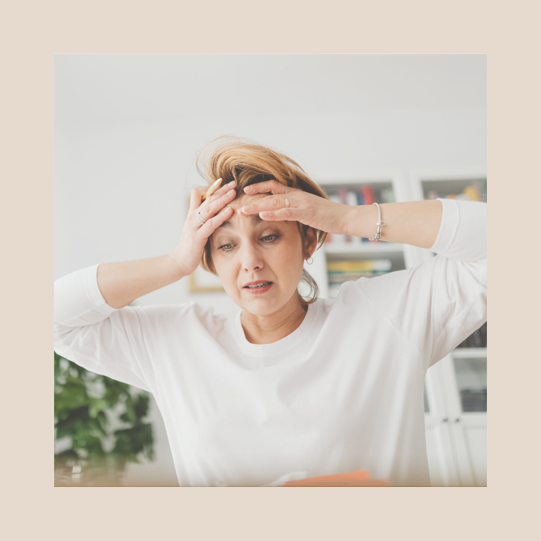 Overwhelmed Christian entrepreneur sitting with hands on head, feeling stressed and burdened by business responsibilities